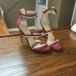 Red high heel shoes with silver accent.